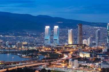 View of Izmir Turley from the sea in the afternoon, with city lights, buildings, and highways.